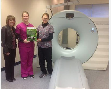 Cassling Account Executive Kathy Warren delivers the plaque to Technologists Amy Yoerger and Glea Hamik.