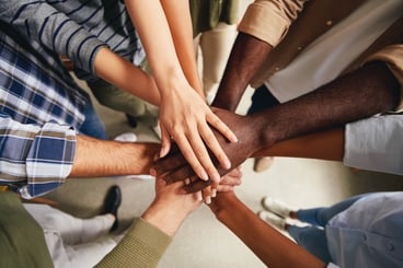 Team with Their Hands in a Circle