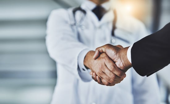 Doctor and man shake hands in the interview stage of the recruitment process