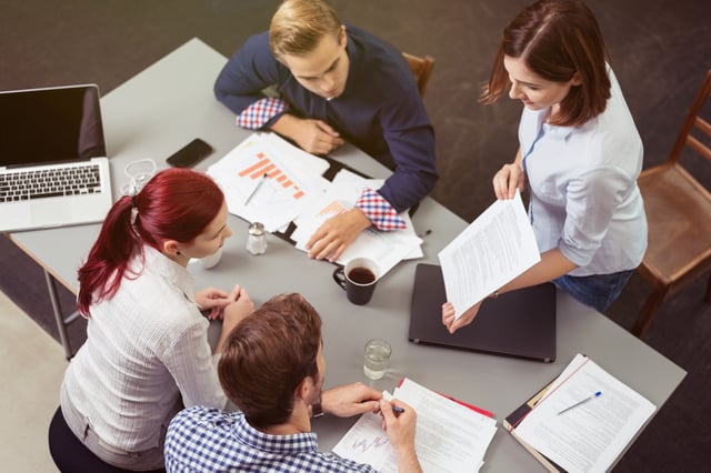 Aerial view of coworkers collaborating around a table