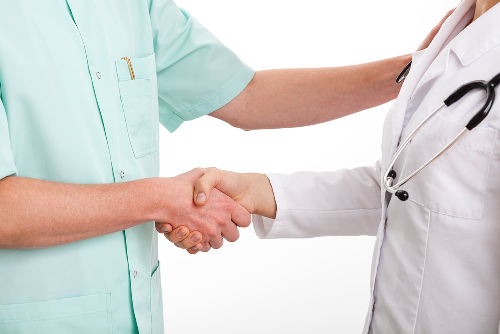 Doctors are shaking hands to say thank you for good teamwork-1