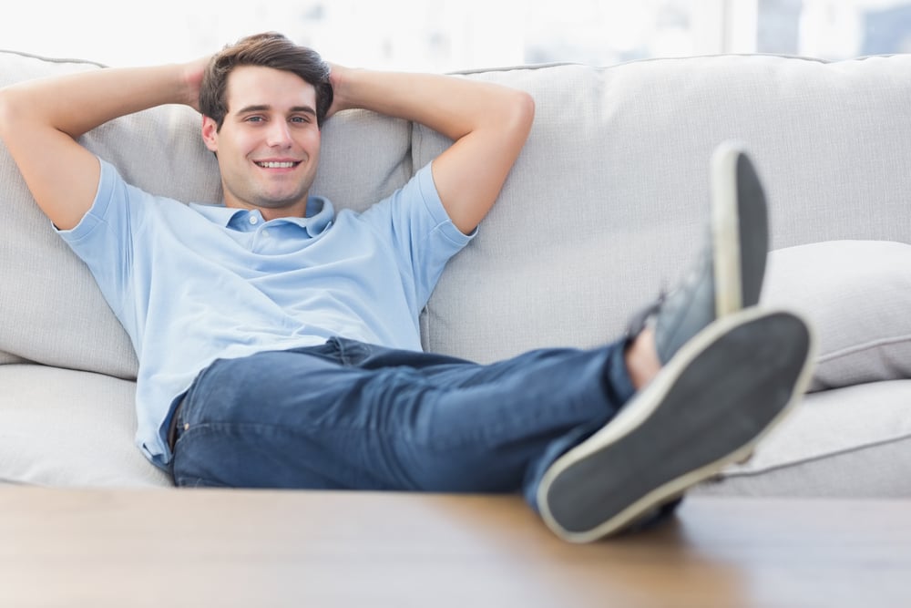 Portrait of a smiling man relaxing on the couch