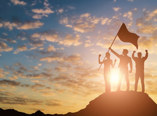 Silhouette of victory team on mountain with sunset and sky background