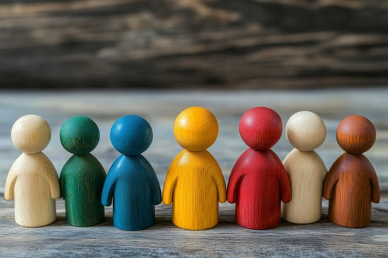 Wooden dolls of different colors to represent diversity.