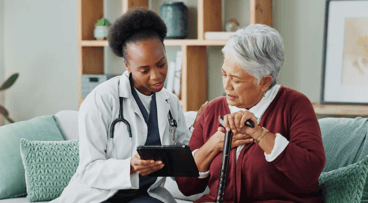Female doctor talking to woman patient