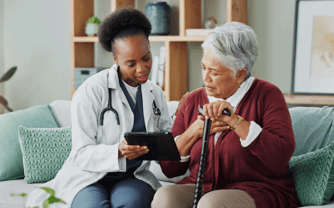 physician talking with older woman